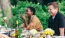 people sitting at a table with food and drinks
