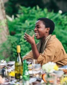 men sitting at a table with food and drinks