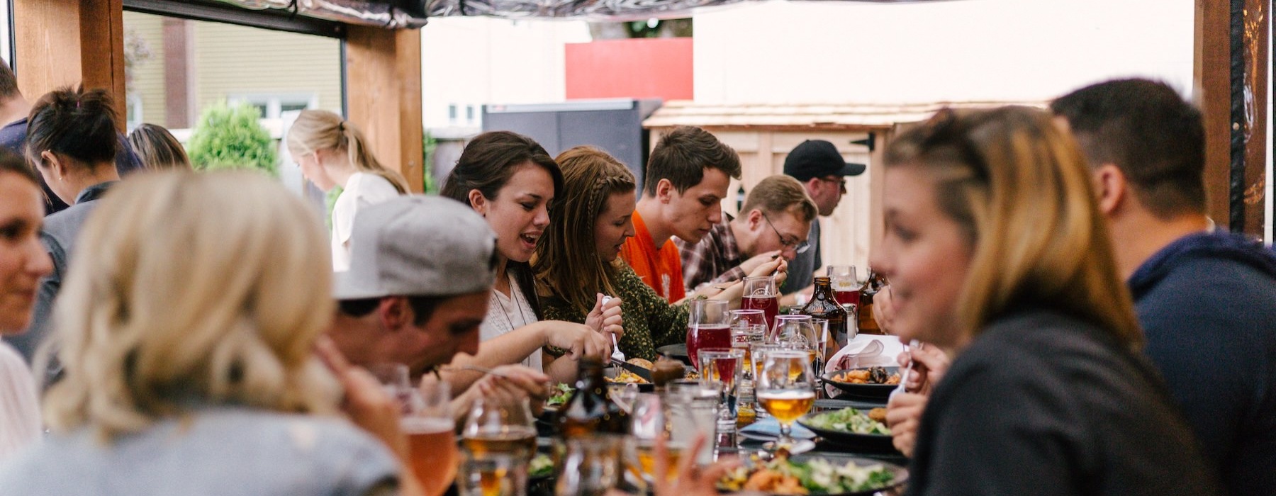 a group of people eating at a restaurant